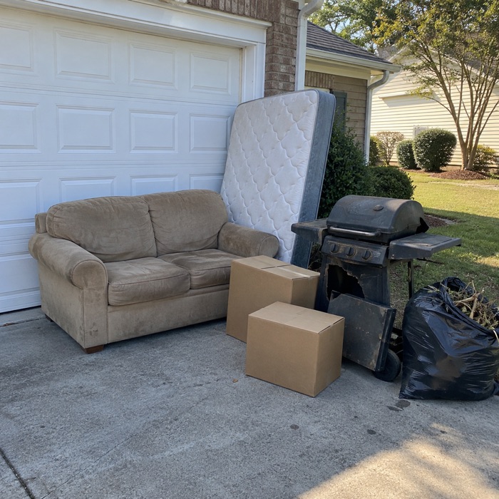 Photo of a junk pile by a garage